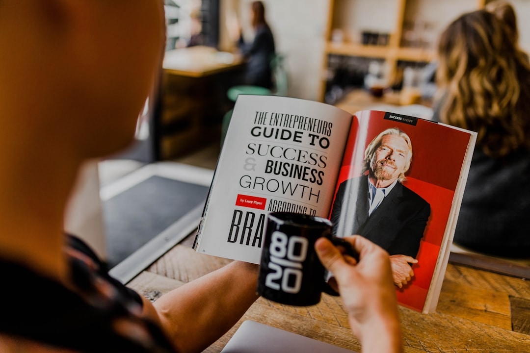 Entrepreneur reviewing business plan on tablet in cafe